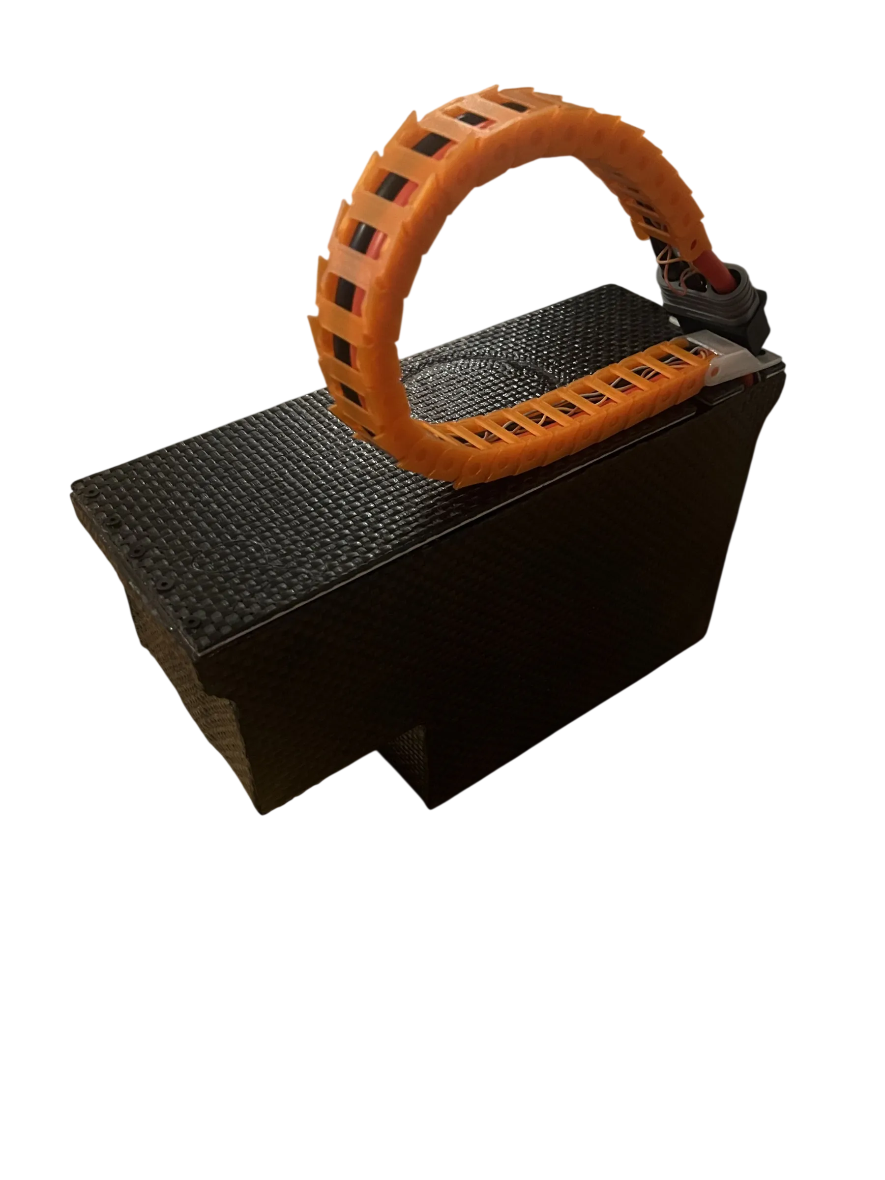 The completed battery sealed inside its carbon-fibre enclosure, with an orange cable drag chain running off the lid